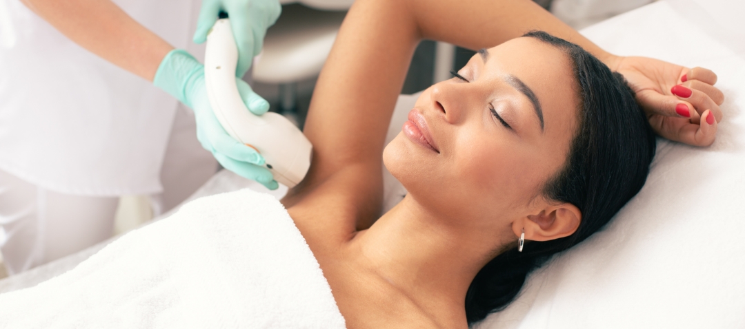 a black woman receives laser treatment to her underarm