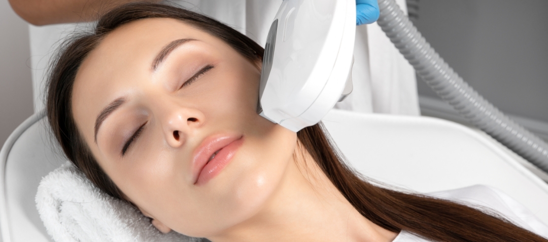 a woman receives treatment from a laser tool on smile lines