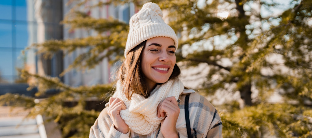 woman smiling outside in winter clothes