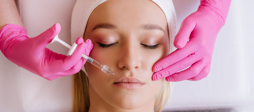 woman getting dermal filler injections in lips